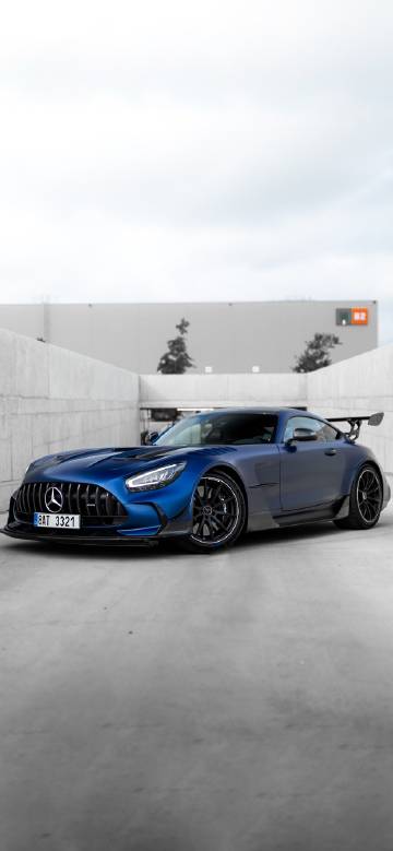 Mercedes-AMG sports car beside modern building