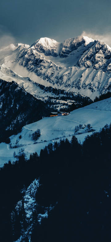 Hut in the snowy mountains on a cold night