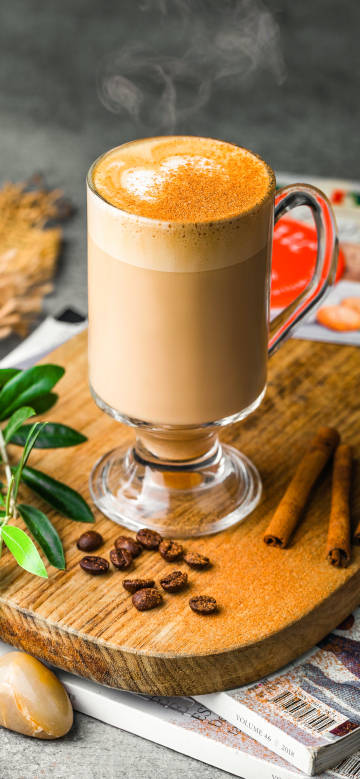 A steaming cup of coffee drink