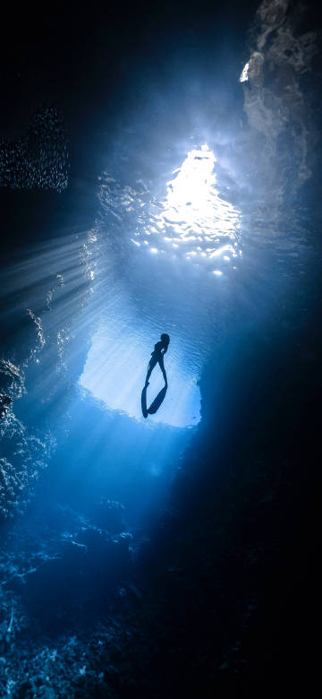 Amazing scene of an underwater cave penetrated by sunlight