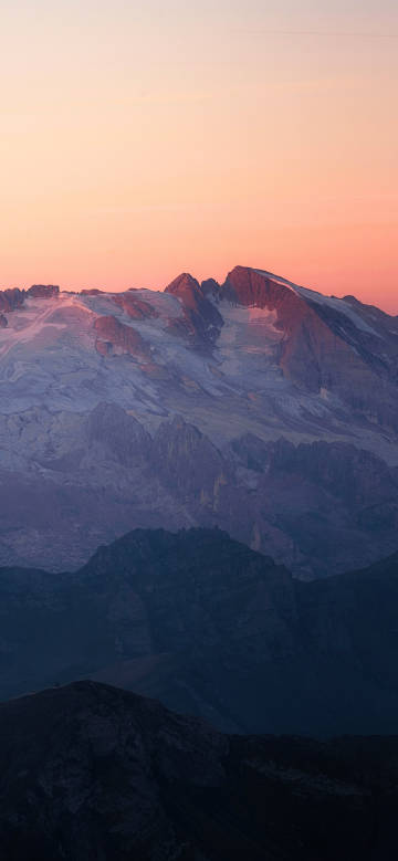 Magnificent moment of snow-capped mountains at sunset