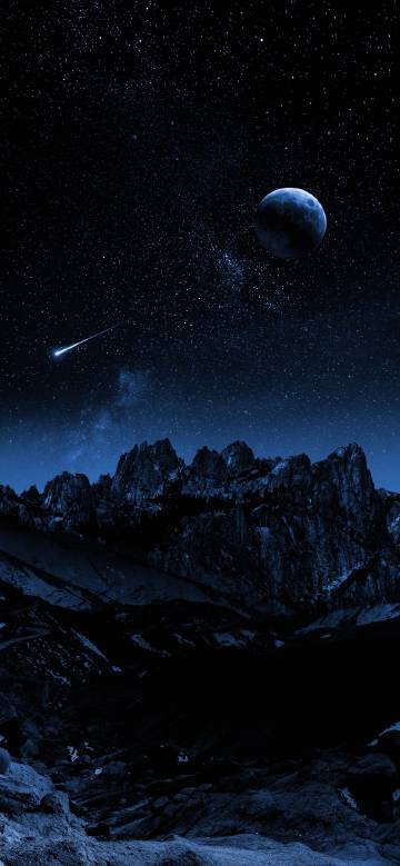 Mountain silhouette under moonlit night and shooting star