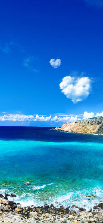 Stunning seaside scenery under heart-shaped white clouds
