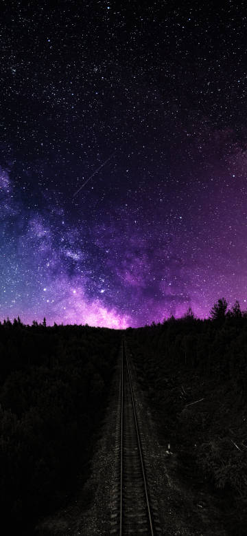 Railway tracks under the purple night sky
