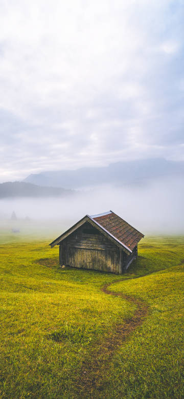 Country wooden House shrouded in mist