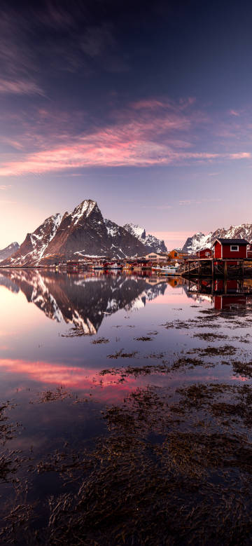 Mountain and water scenery under pink glow
