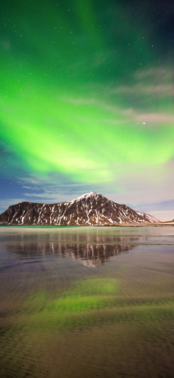 Green aurora shining on the tranquil lake