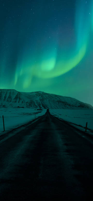 Aurora over snowy road
