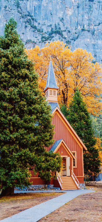 Church in mountain forest during autumn