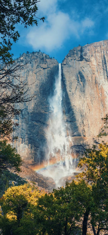 Waterfall and rainbow on the cliff
