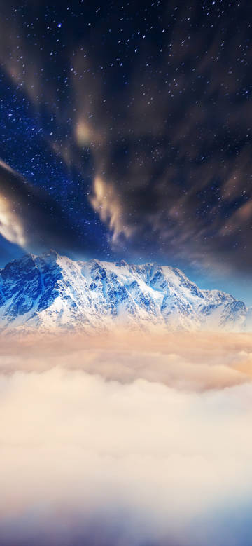 Starry sky above snow-capped mountains and cloud sea