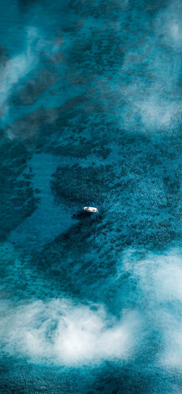 Aerial view of a boat on blue sea