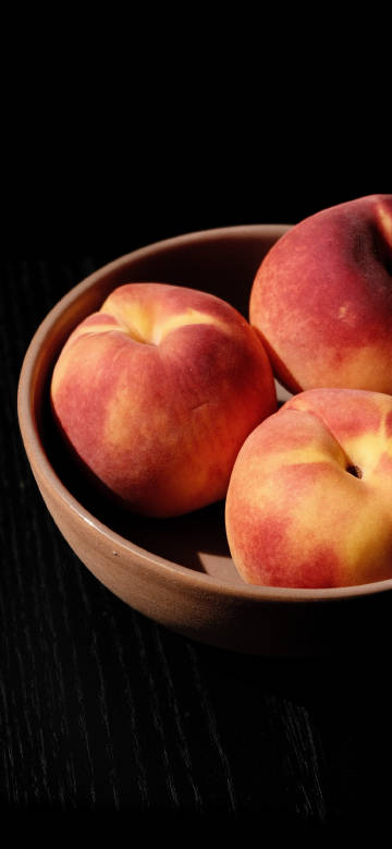 Close-up of peaches against black background