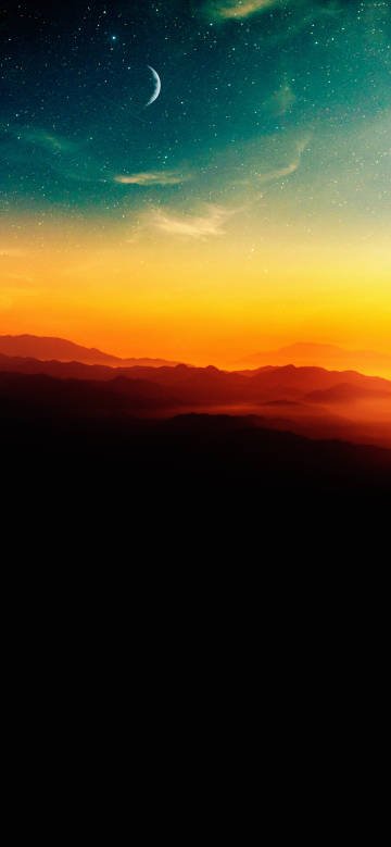 Stars, moon, and mountains during sunrise