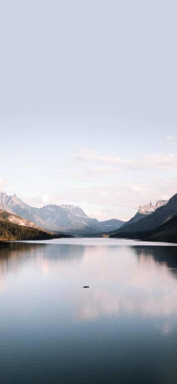 Beautiful lake reflecting mountains and sky