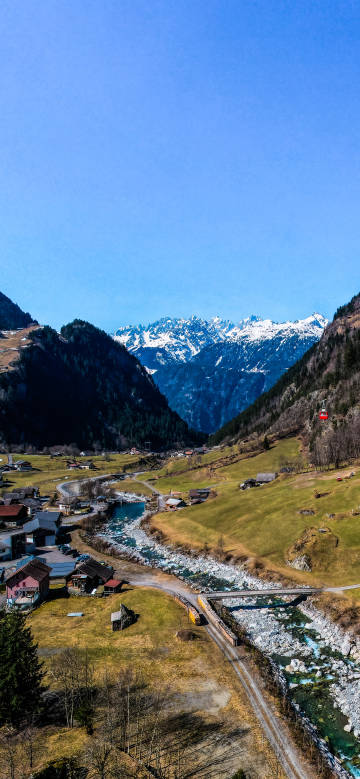Charming scenery of snow-capped mountains, valley, and village