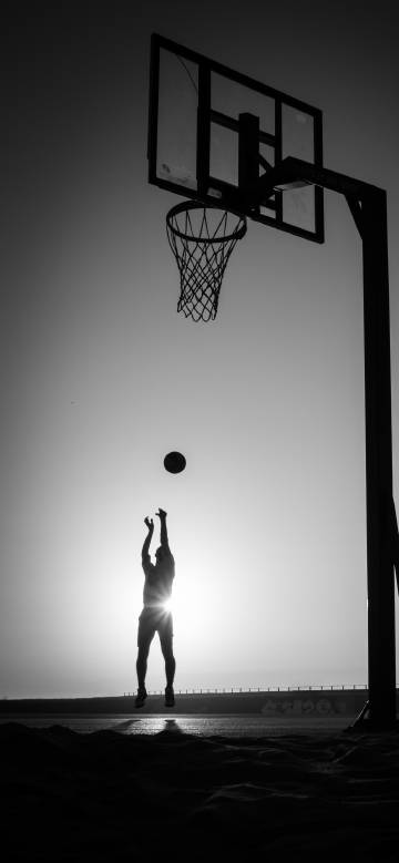 Basketball shooting moment against the light
