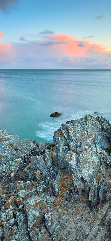 Seaside rocks and sea under the setting sun