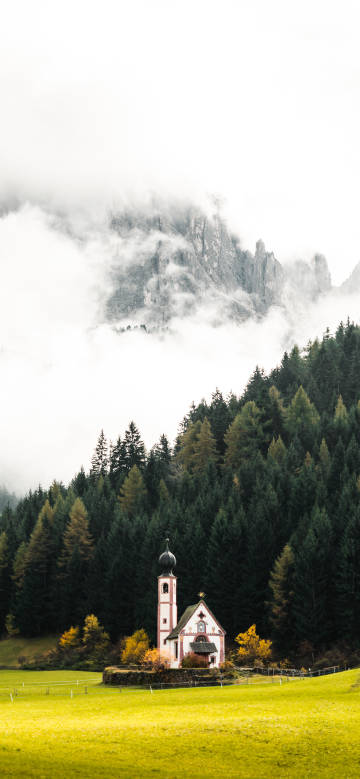 Scenery of the chapel in misty mountain forest