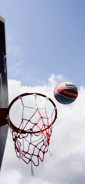 Basketball flying towards the hoop