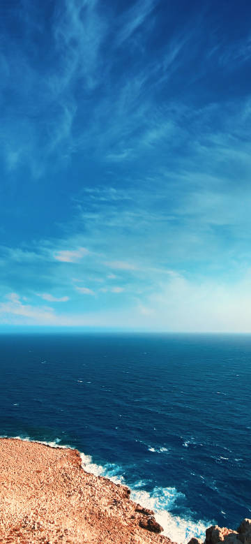 Rocky seashore and vast blue sky