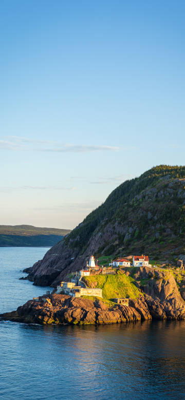 Lighthouse and houses on the seaside cliff