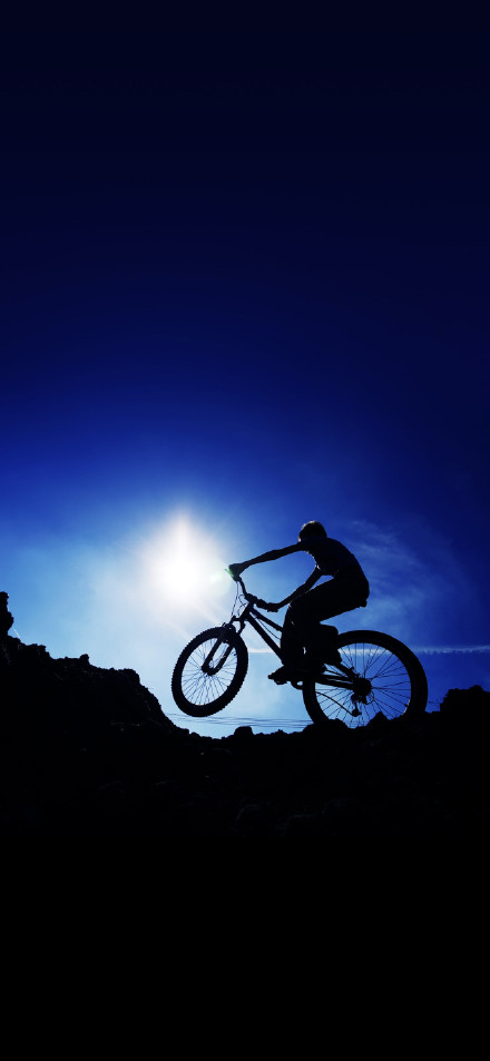 A person cycling in the sun