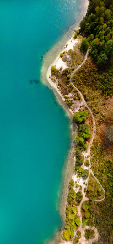 Overlooking the clear blue-green lake water on the shore