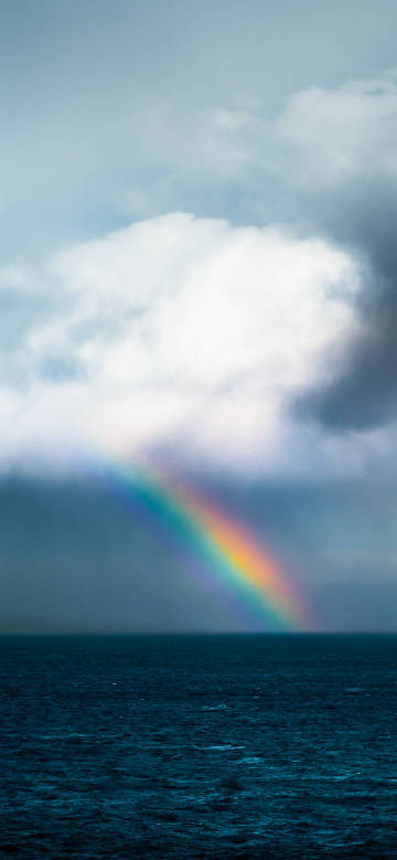 Beautiful scene of a rainbow over the sea
