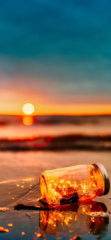 Dreamy glass bottle at sunset
