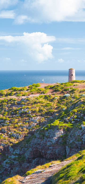 Coastal stone tower under the blue sky