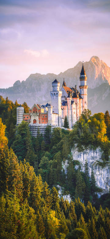 Neuschwanstein Castle is surrounded by lush forests and majestic mountains