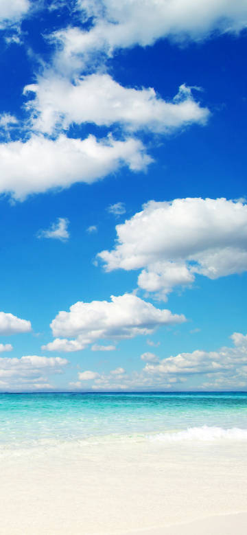 Clear sea water scenery under blue sky and white clouds
