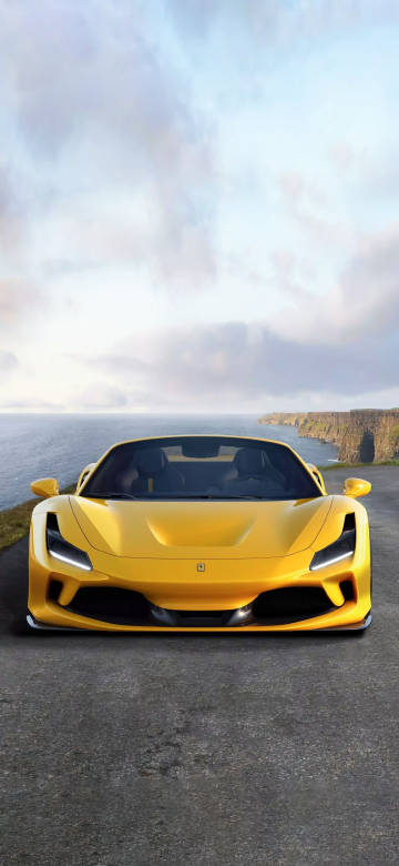 Cool yellow Ferrari sports car parked on the cliff